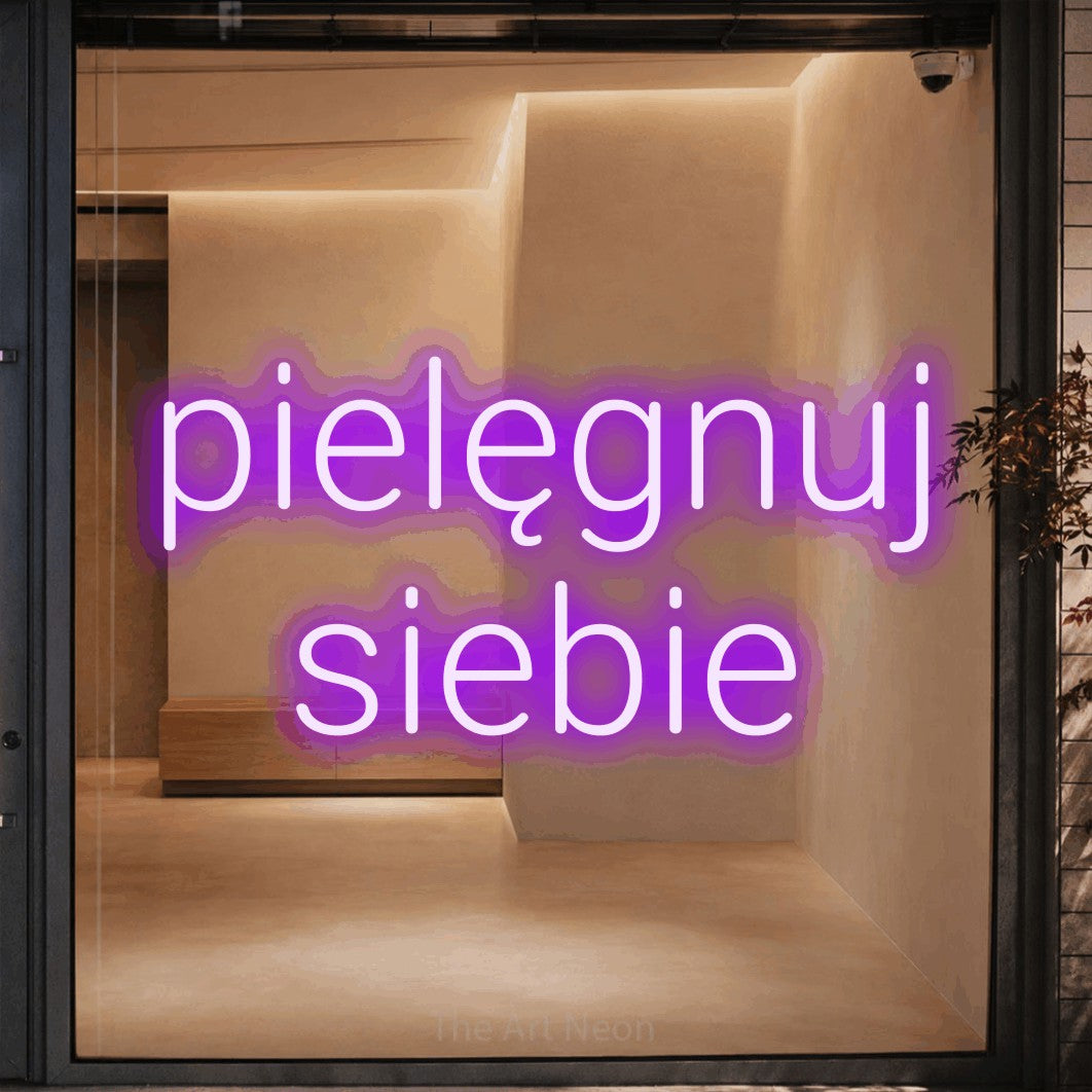 LED neon sign reading “pielęgnuj siebie”, arranged in two lines.