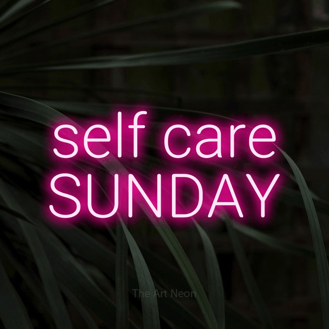 LED neon sign reading “self care SUNDAY”, arranged in two lines.