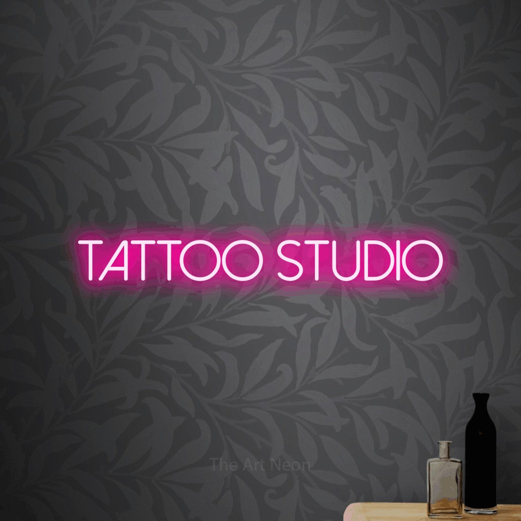 LED neon sign reading “TATTOO studio”, arranged in a single line.