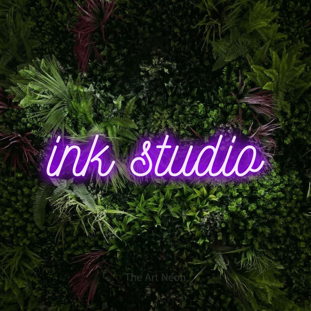 LED neon sign reading “ink studio”, arranged in a single line.