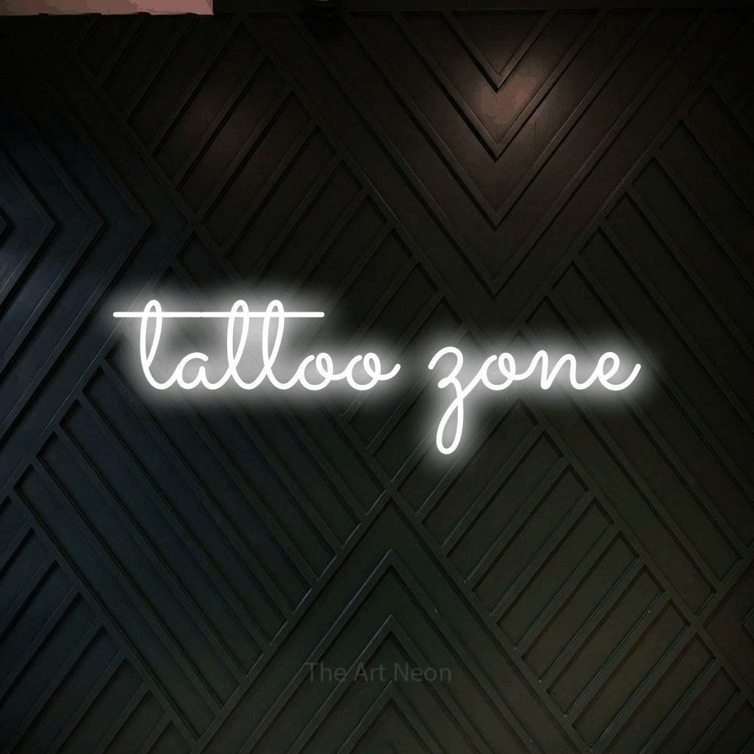 LED neon sign reading “tattoo zone”, arranged in a single line.