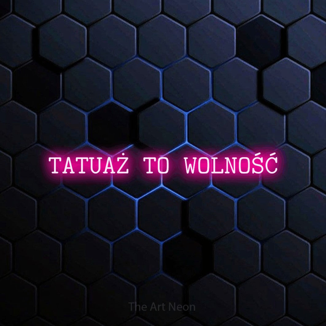 LED neon sign reading “TATUAŻ TO WOLNOŚĆ”, arranged in a single line.