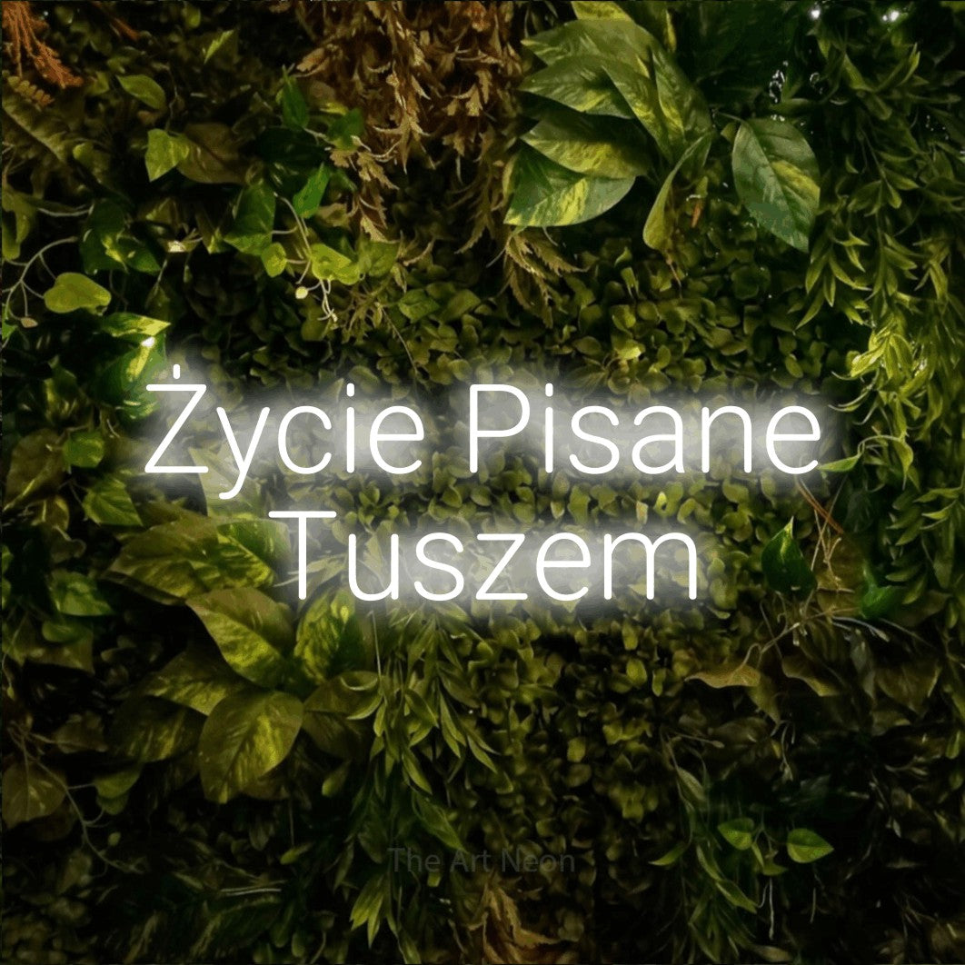 LED neon sign reading “Życie Pisane Tuszem”, arranged in two lines.