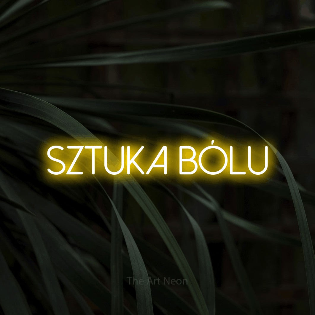 LED neon sign reading “SZTUKA bólu”, arranged in a single line.