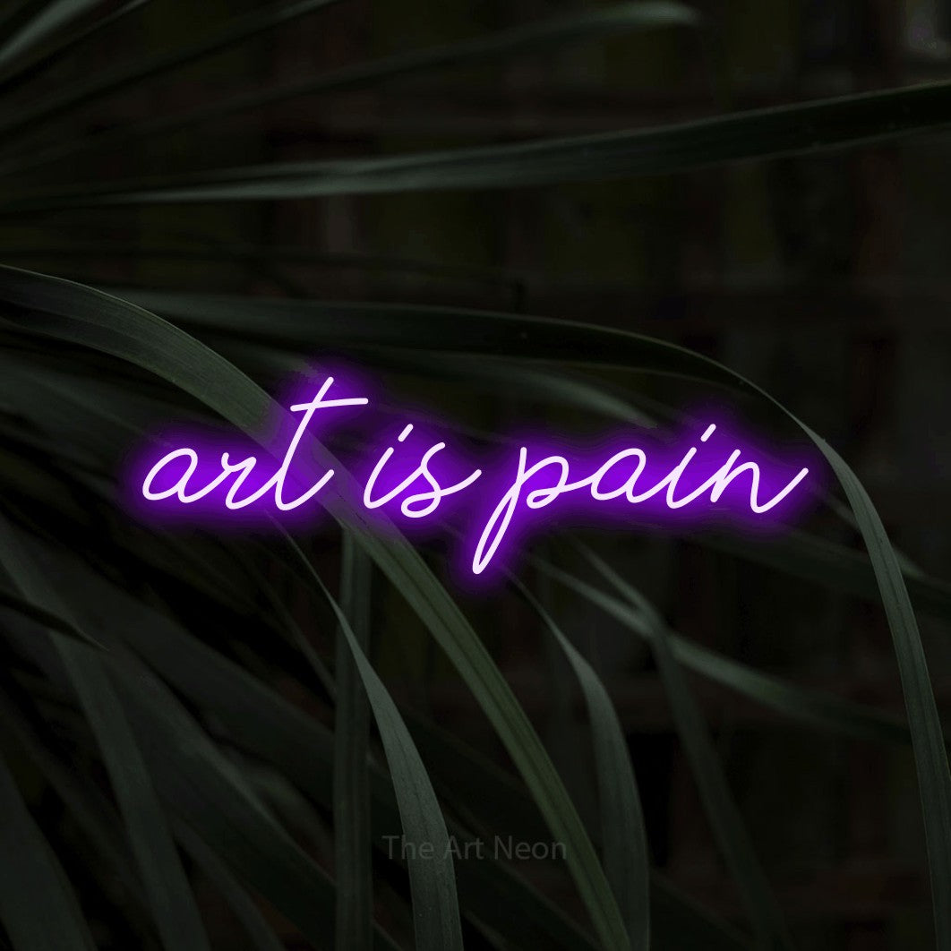 LED neon sign reading “art is pain”, arranged in a single line.