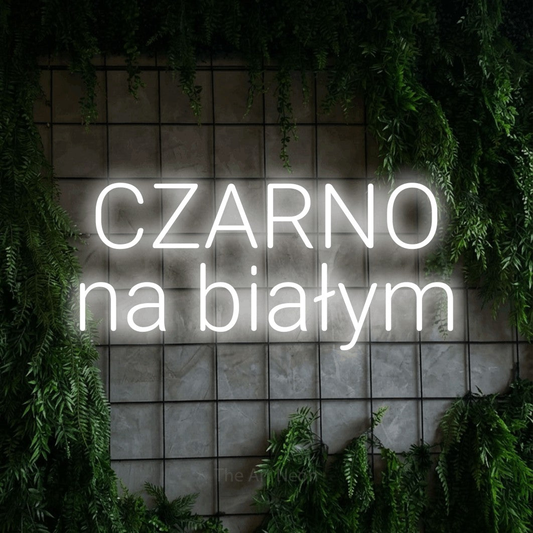 LED neon sign reading “CZARNO na białym”, arranged in two lines.