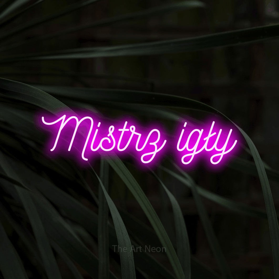 LED neon sign reading “Mistrz igły”, arranged in a single line.