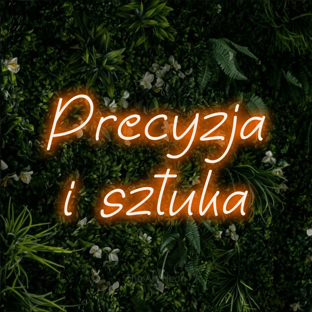LED neon sign reading “Precyzja i sztuka”, arranged in two lines.