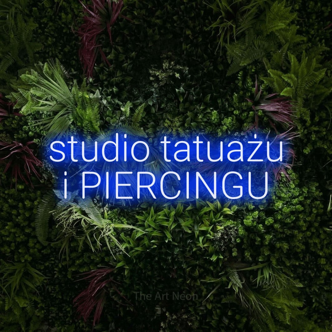 LED neon sign reading “studio tatuażu i PIERCINGU”, arranged in two lines.