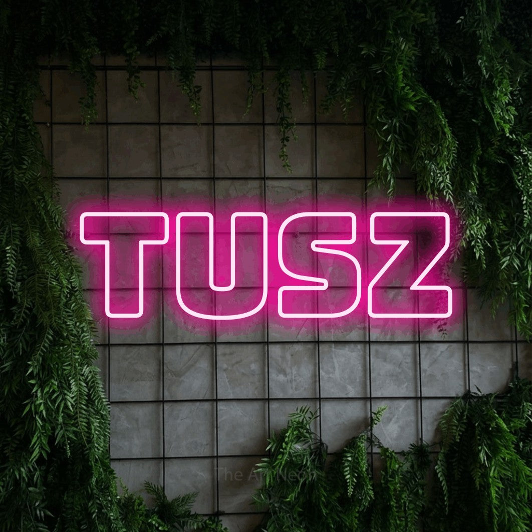 LED neon sign reading “Tusz”, arranged in a single line.