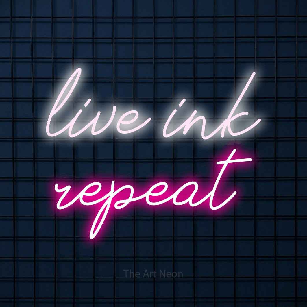 LED neon sign reading “live ink repeat”, arranged in two lines.