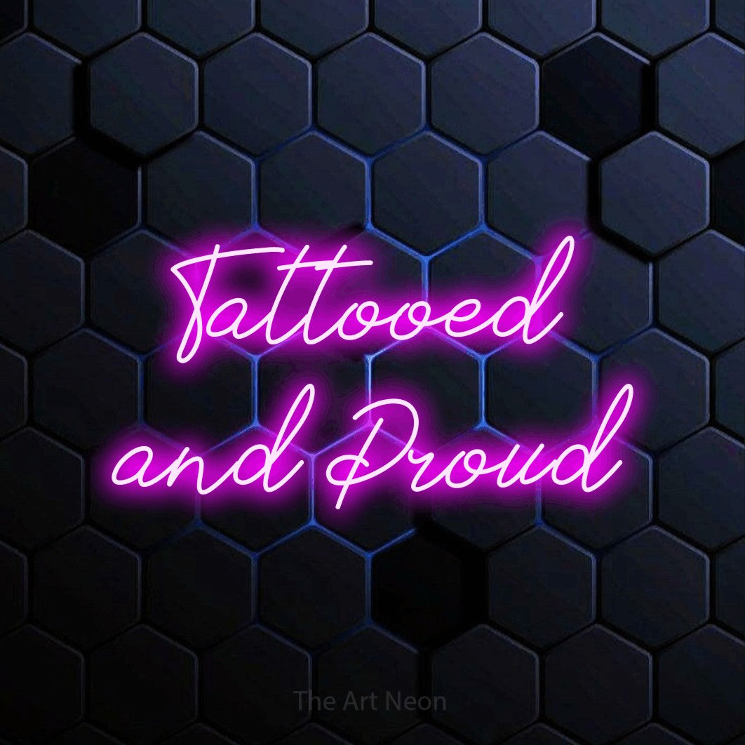 LED neon sign reading “Tattooed and Proud”, arranged in two lines.
