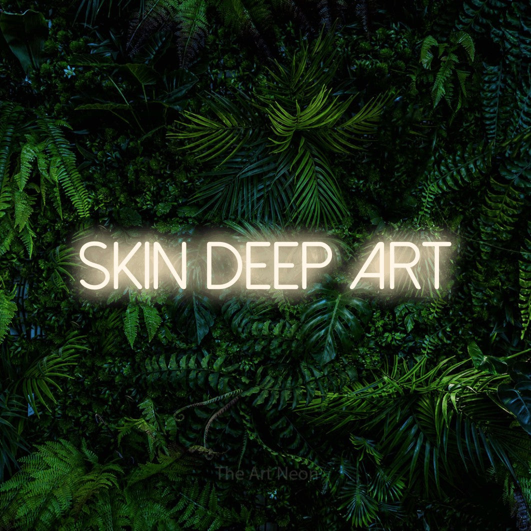 LED neon sign reading “skin deep art”, arranged in a single line.
