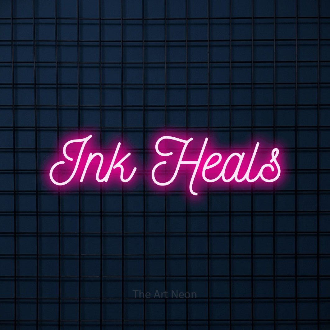 LED neon sign reading “Ink Heals”, arranged in a single line.