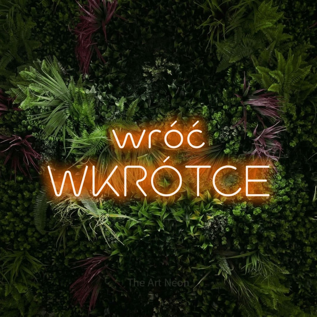 LED neon sign reading “wróć WKRÓTCE”, arranged in two lines.