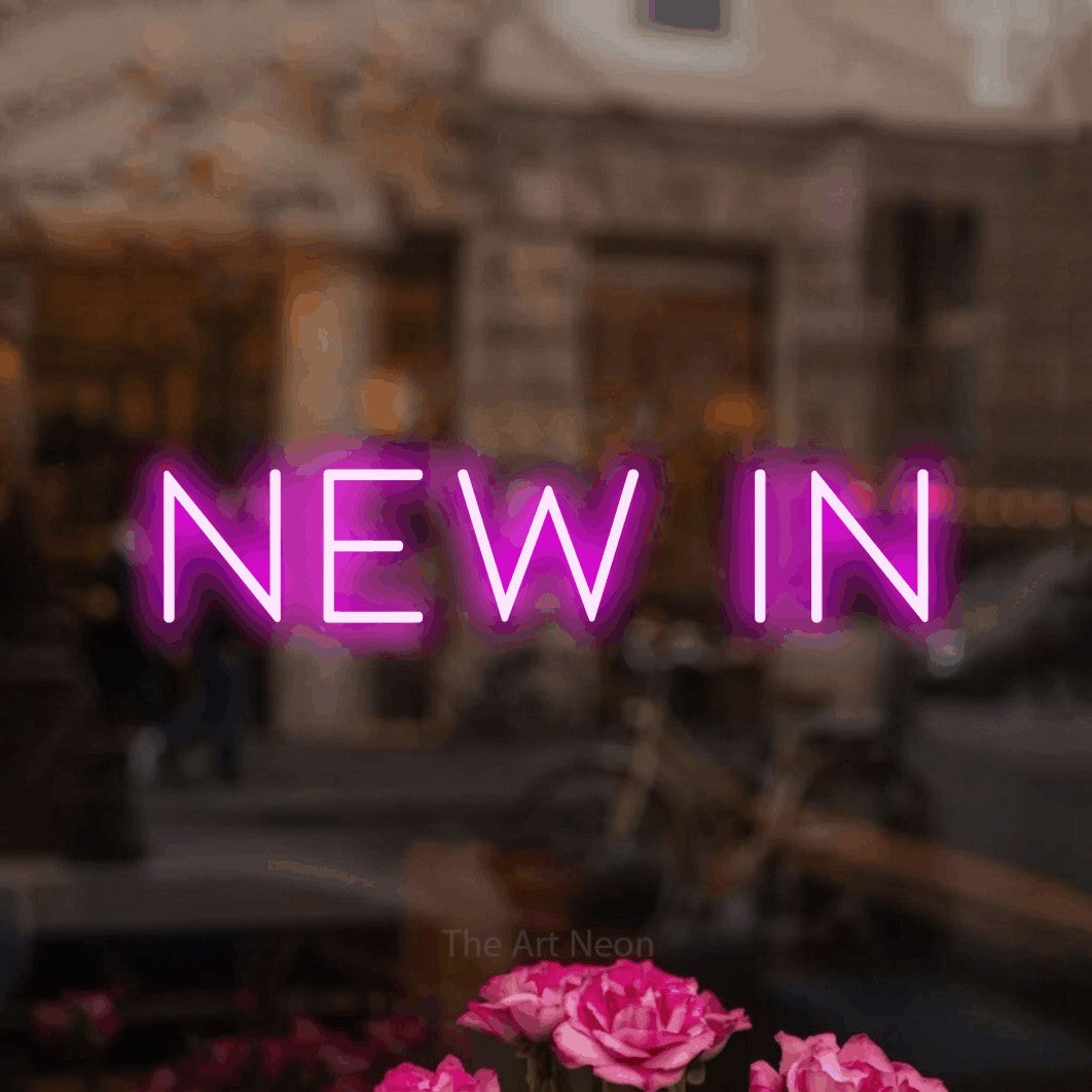 LED neon sign reading “NEW IN”, arranged in a single line.