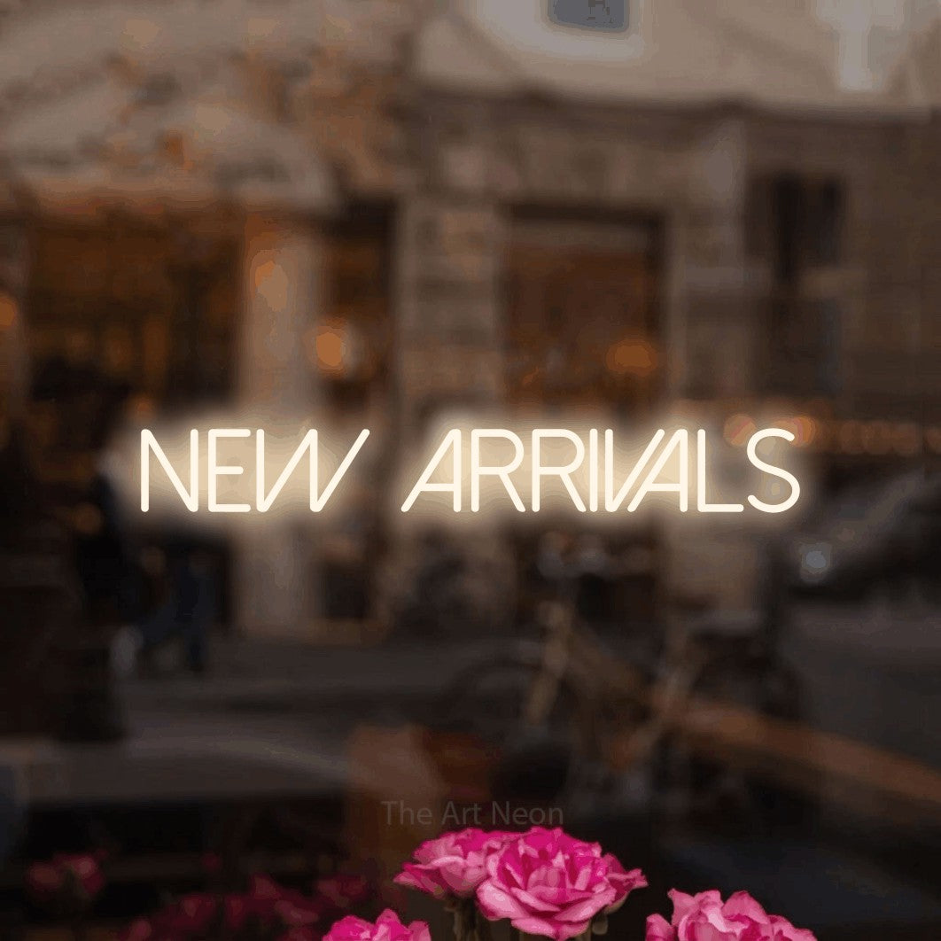LED neon sign reading “new arrivals”, arranged in a single line.