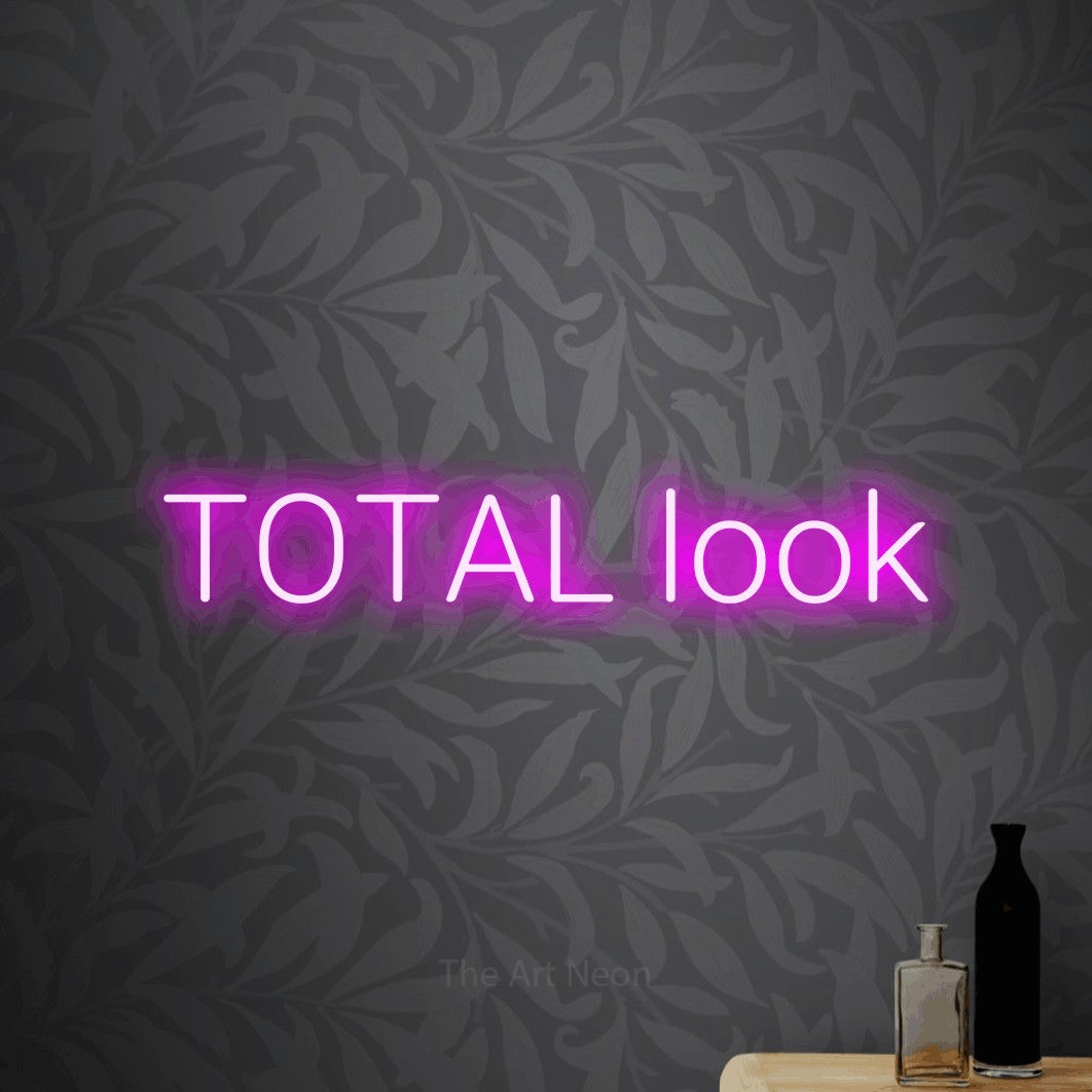 LED neon sign reading “TOTAL look”, arranged in a single line.