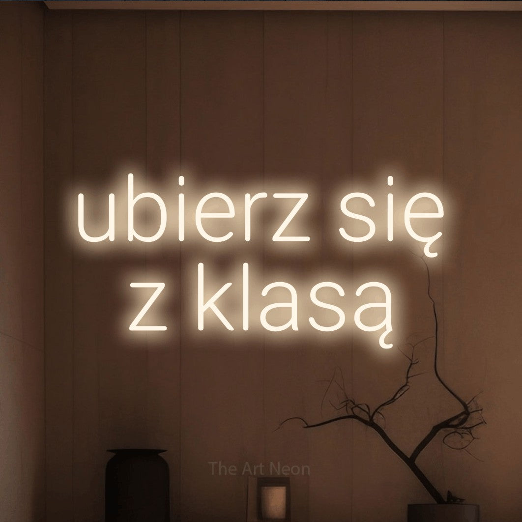 LED neon sign reading “ubierz się z klasą”, arranged in two lines.