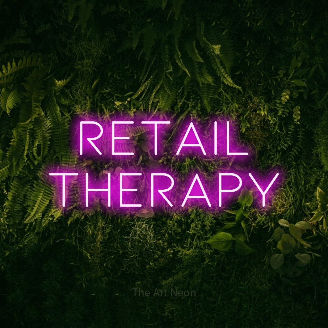 LED neon sign reading “Retail Therapy”, arranged in two lines.