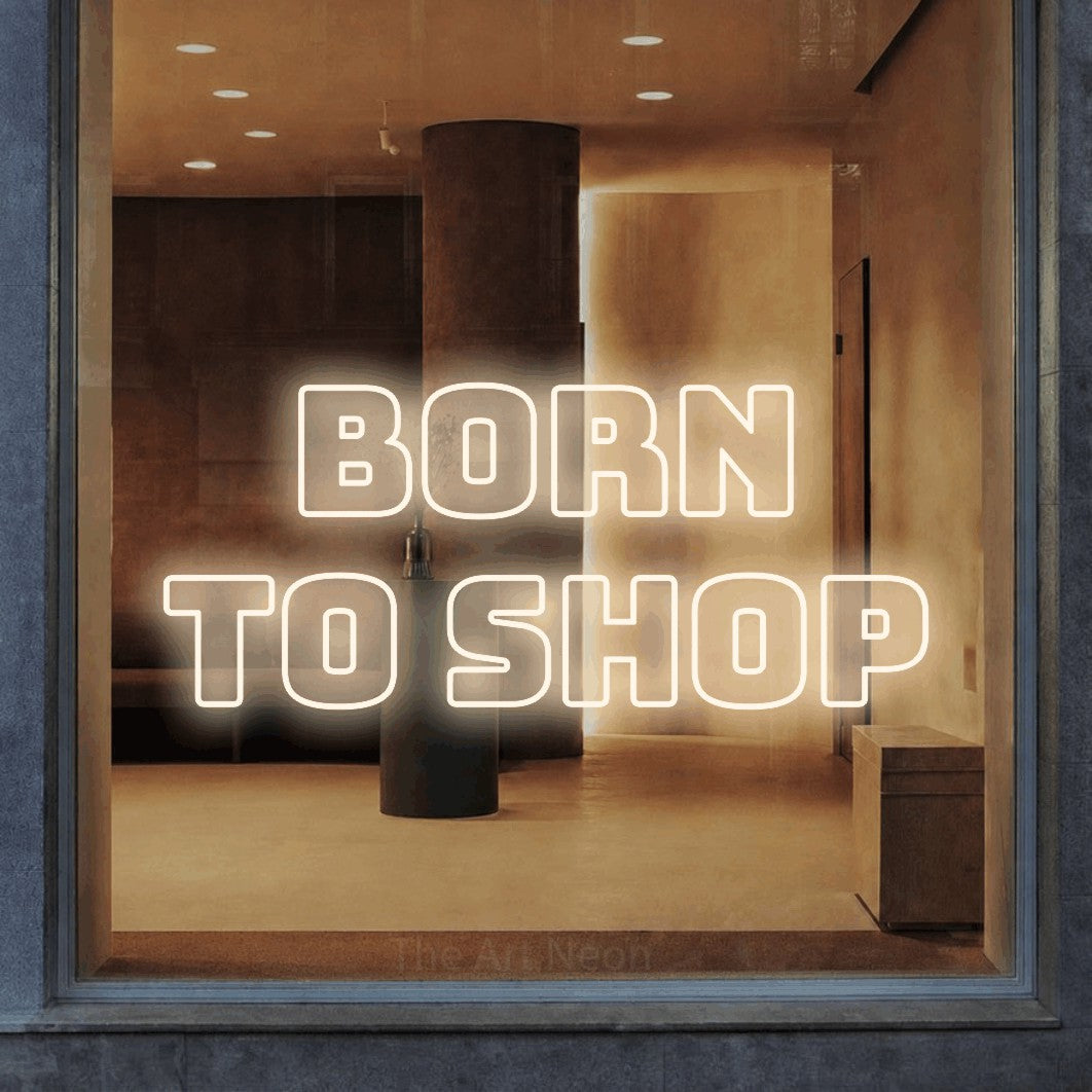 LED neon sign reading “Born to Shop”, arranged in two lines.