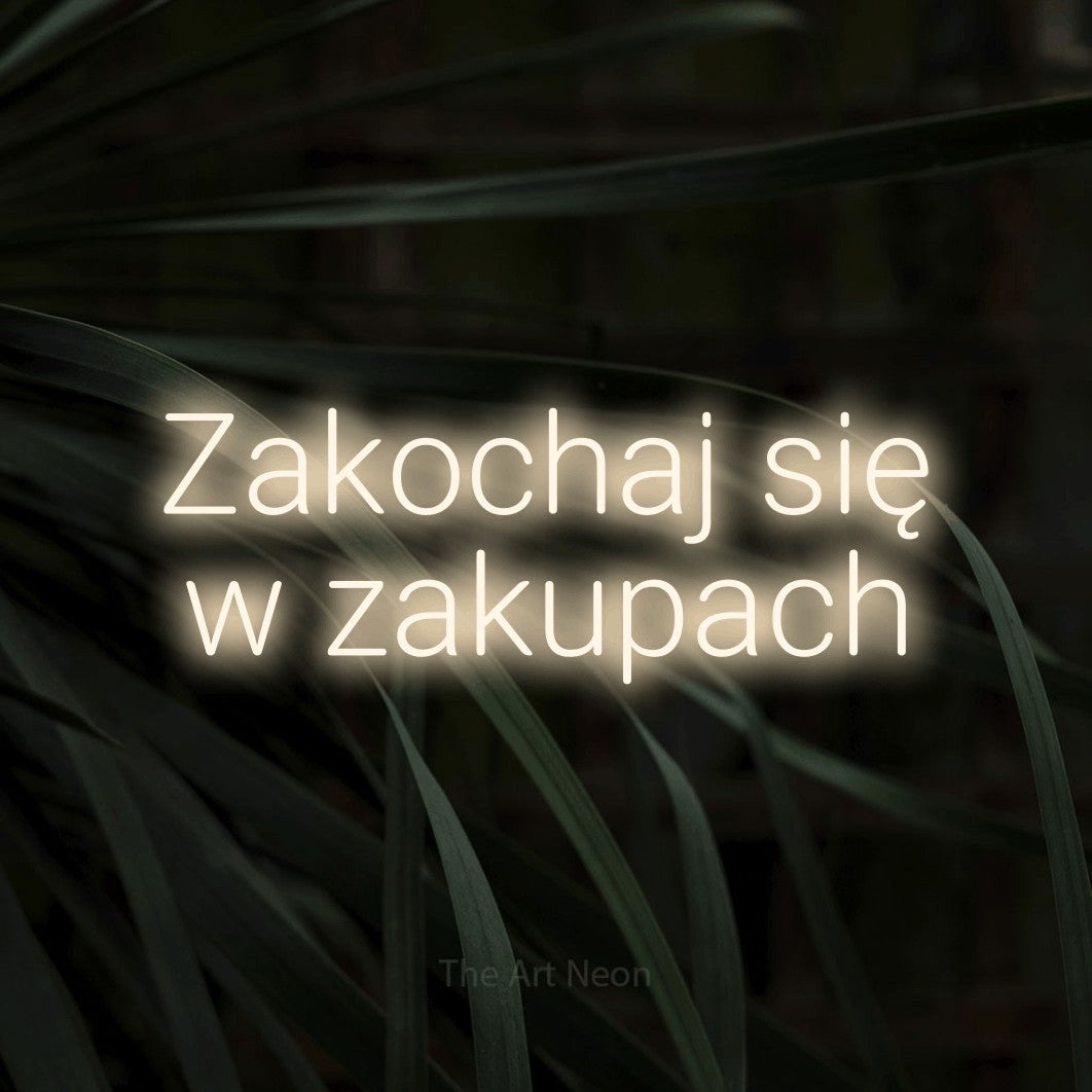 LED neon sign reading “Zakochaj się w zakupach”, arranged in two lines.