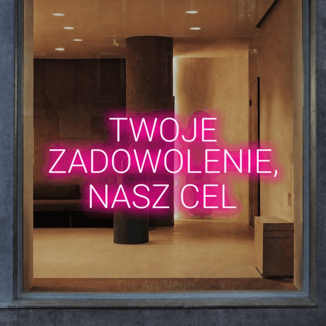 LED neon sign reading “TWOJE ZADOWOLENIE, NASZ CEL”, arranged in three lines.