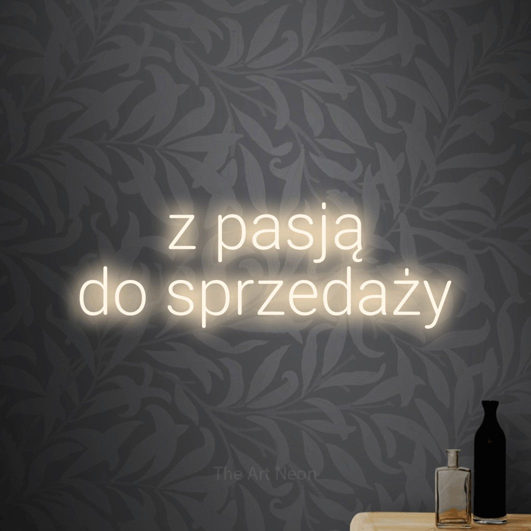 LED neon sign reading “z pasją do sprzedaży”, arranged in two lines.