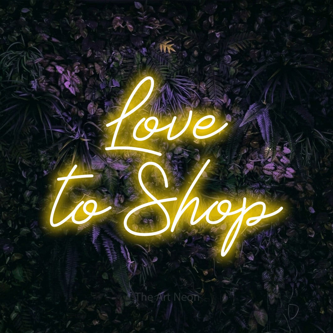 LED neon sign reading “Love to Shop”, arranged in two lines.