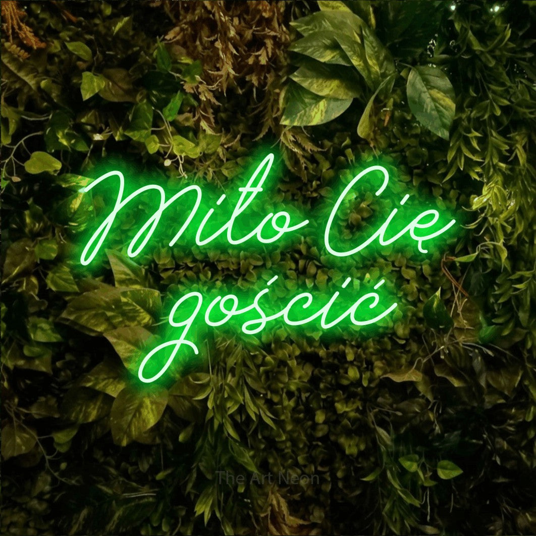 LED neon sign reading “Miło Cię gościć”, arranged in two lines.