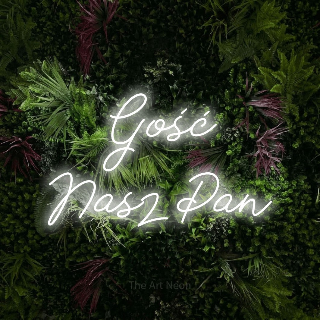 LED neon sign reading “Gość Nasz Pan”, arranged in two lines.