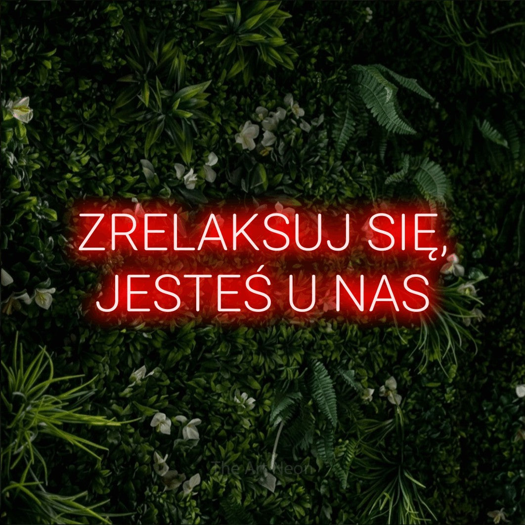 LED neon sign reading “ZRELAKSUJ SIĘ, JESTEŚ U NAS”, arranged in two lines.