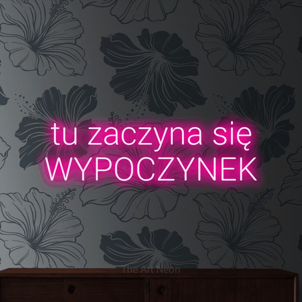 LED neon sign reading “tu zaczyna się WYPOCZYNEK”, arranged in two lines.