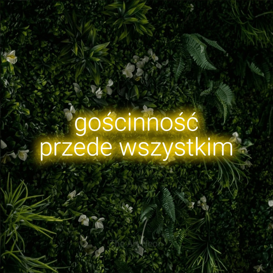 LED neon sign reading “gościnność przede wszystkim”, arranged in two lines.