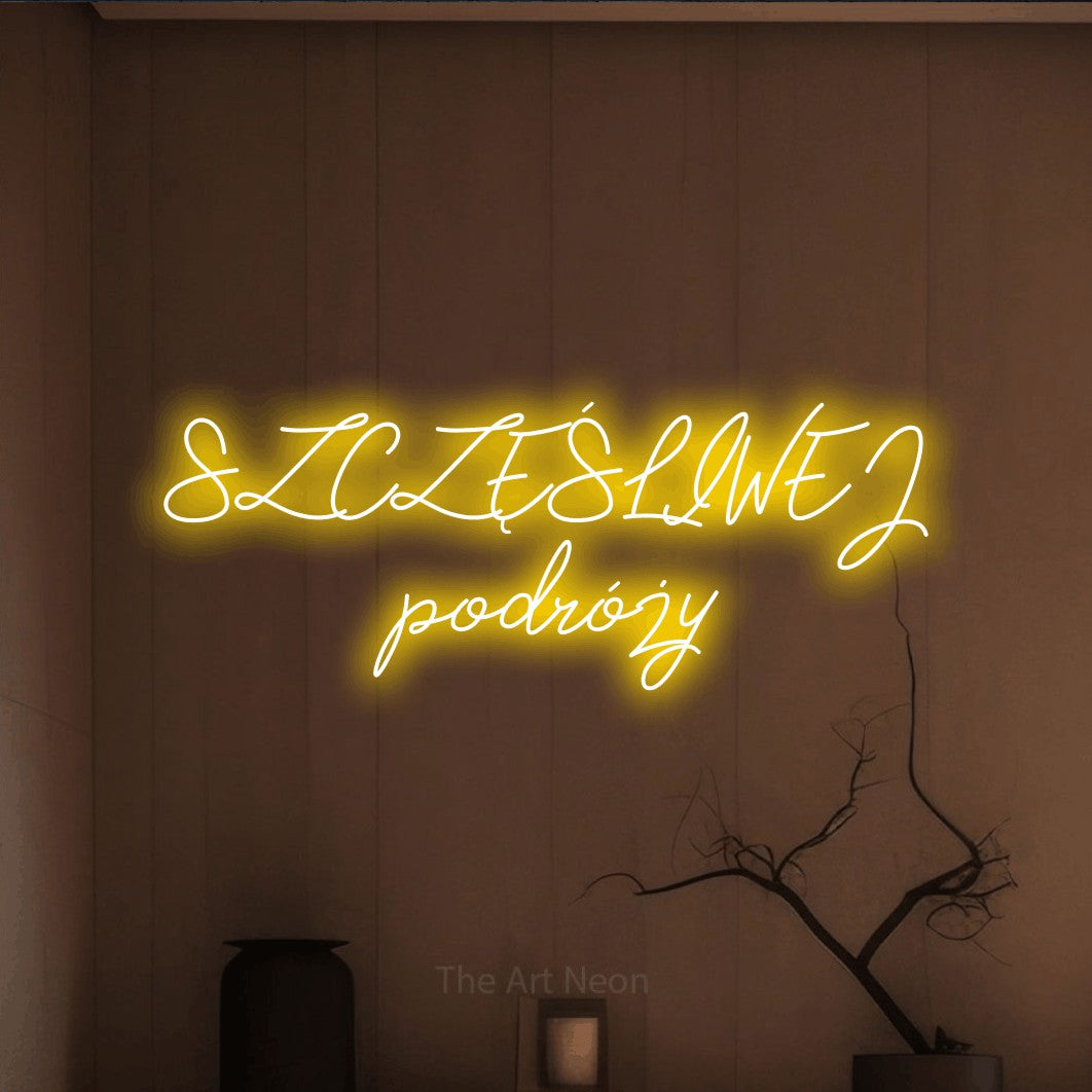LED neon sign reading “SZCZĘŚLIWEJ podróży”, arranged in two lines.