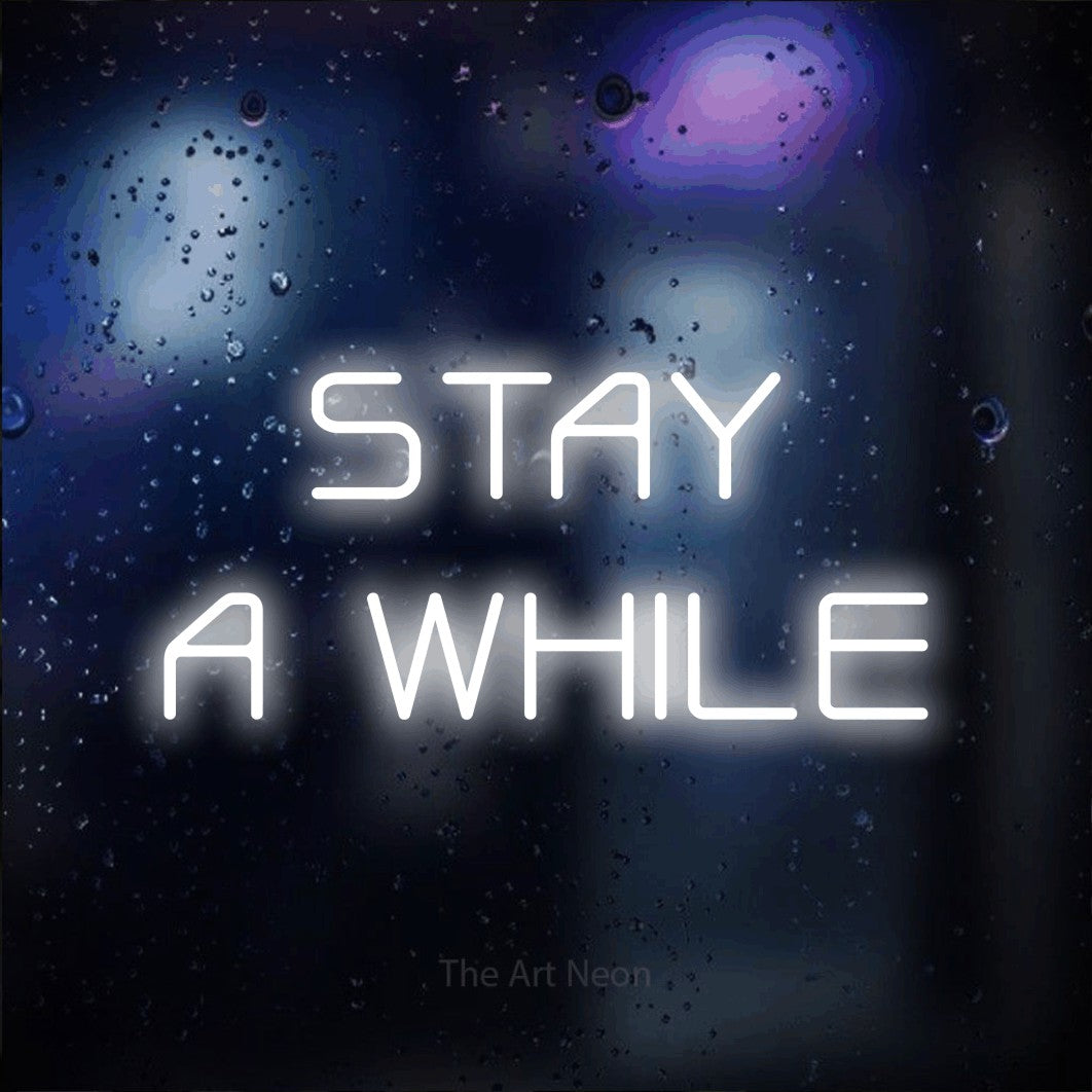LED neon sign reading “STAY A WHILE”, arranged in two lines.