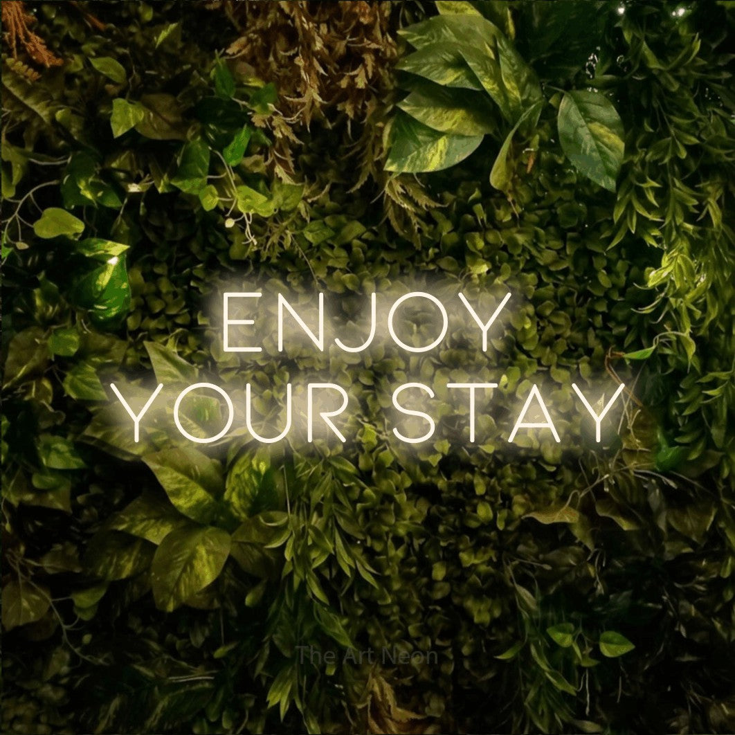 LED neon sign reading “Enjoy Your Stay”, arranged in two lines.