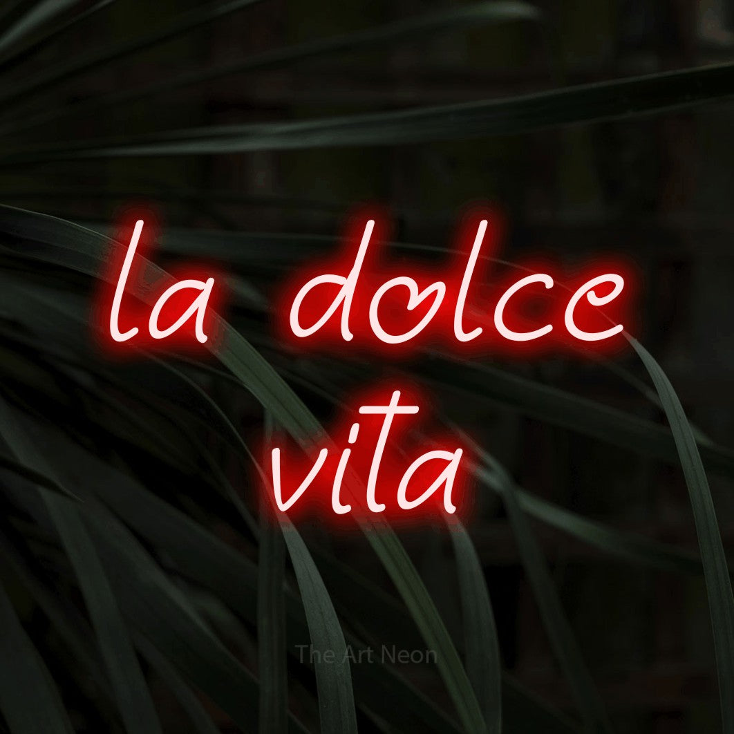 LED neon sign reading “la dolce vita”, arranged in two lines.