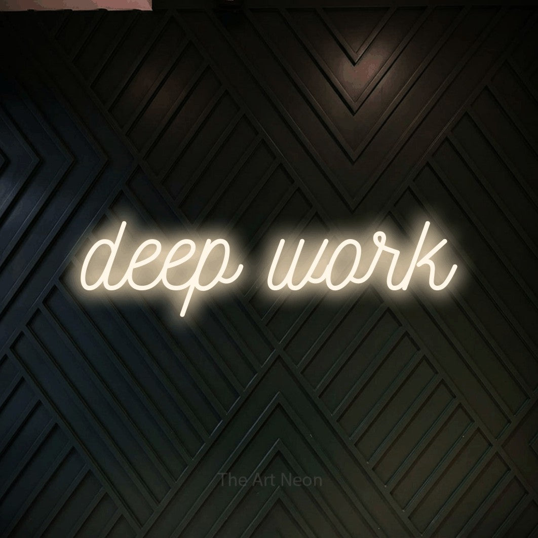 LED neon sign reading “deep work”, arranged in a single line.