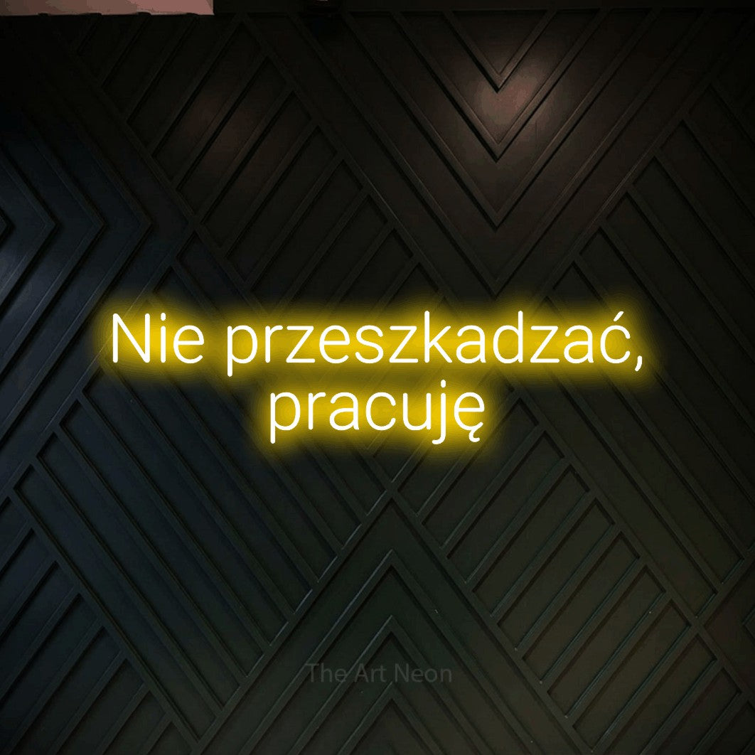 LED neon sign reading “Nie przeszkadzać, pracuję”, arranged in two lines.
