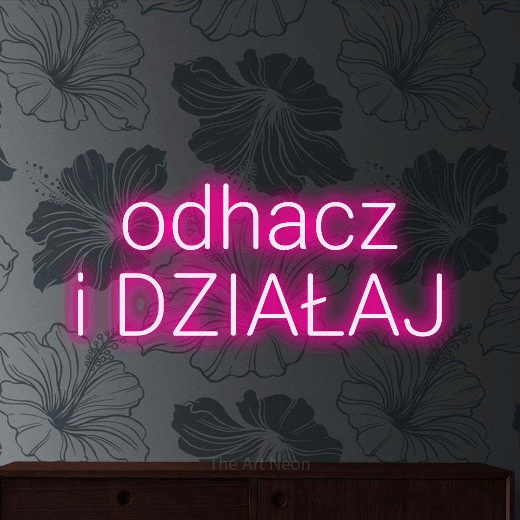 LED neon sign reading “odhacz i DZIAŁAJ”, arranged in two lines.