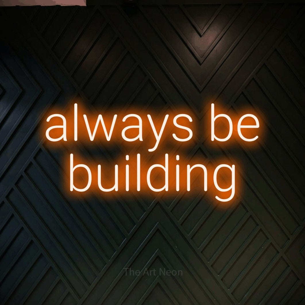 LED neon sign reading “always be building”, arranged in two lines.