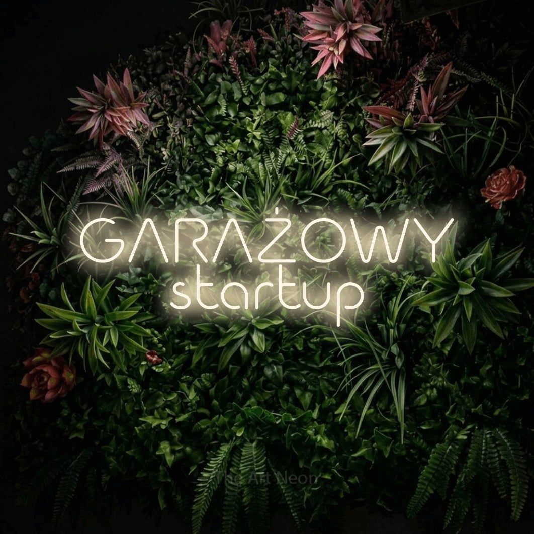 LED neon sign reading “GARAŻOWY startup”, arranged in two lines.