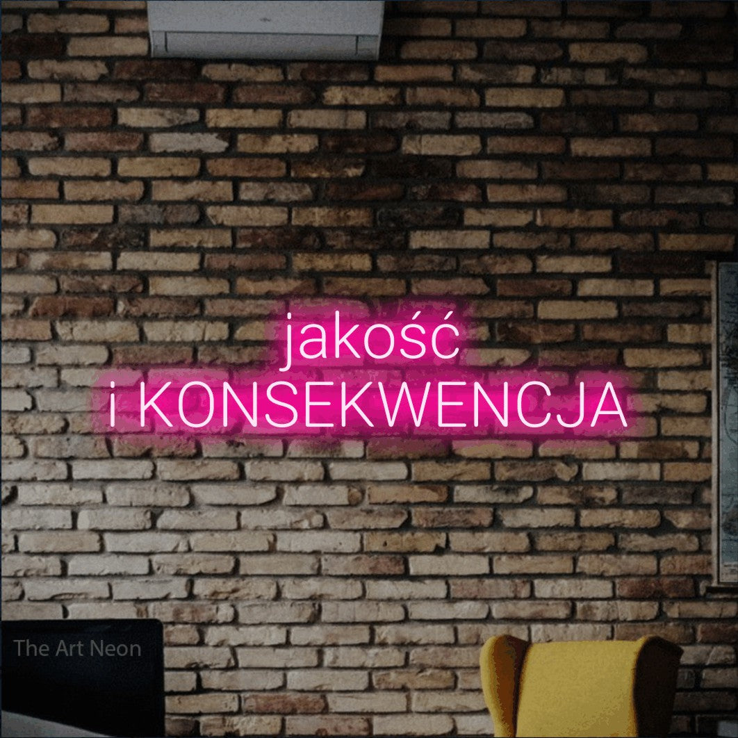 LED neon sign reading “jakość i KONSEKWENCJA”, arranged in two lines.
