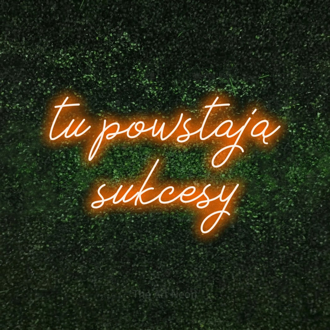 LED neon sign reading “tu powstają sukcesy”, arranged in two lines.