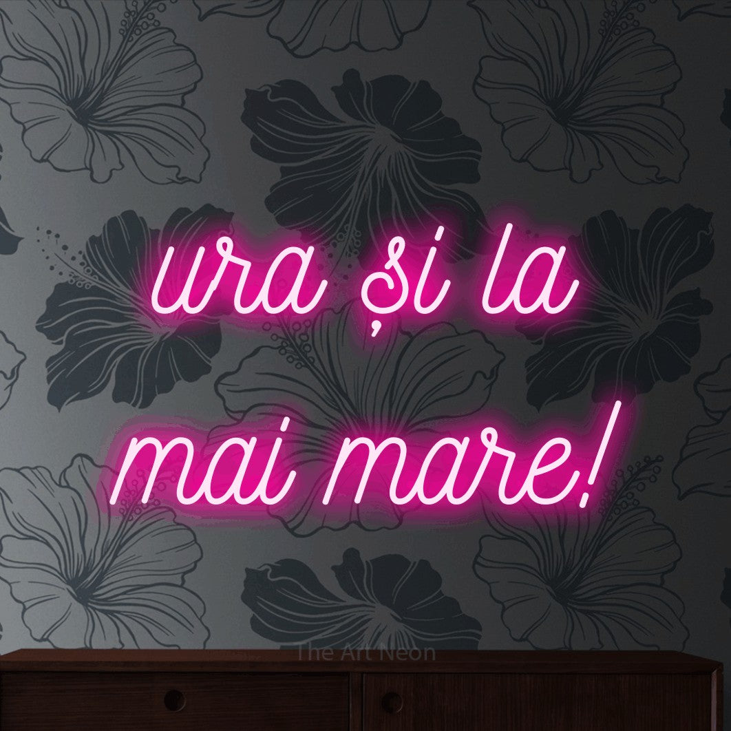 LED neon sign reading “ura și la mai mare!”, arranged in two lines.