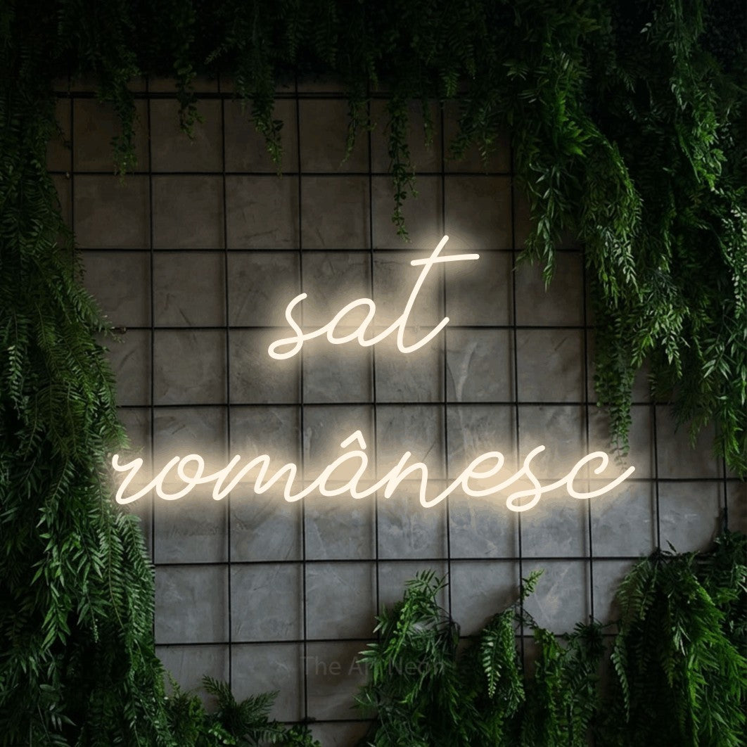 LED neon sign reading “sat românesc”, arranged in two lines.