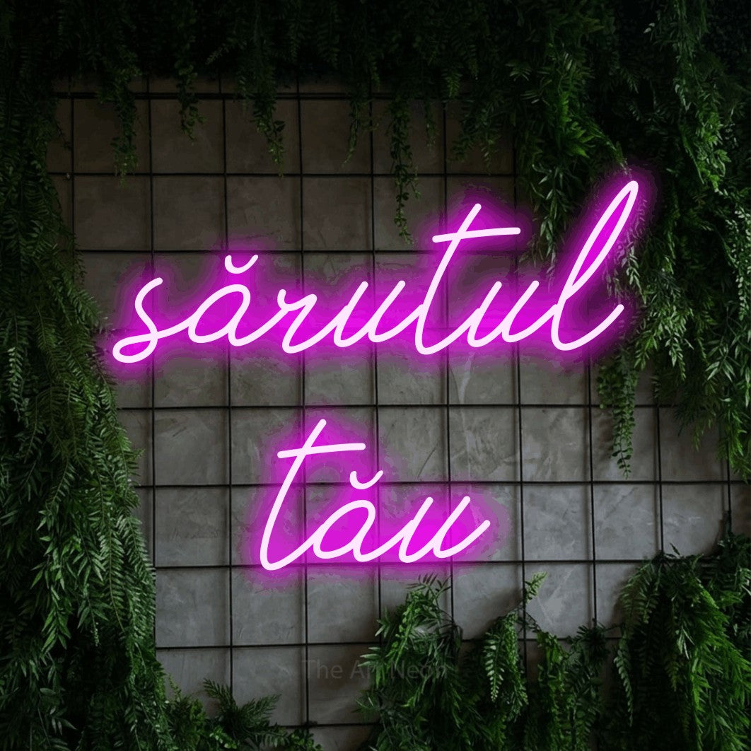 LED neon sign reading “sărutul tău”, arranged in two lines.