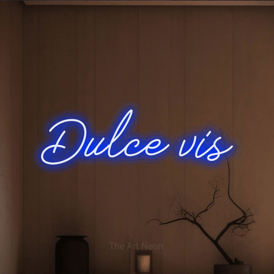 LED neon sign reading “Dulce vis”, arranged in a single line.