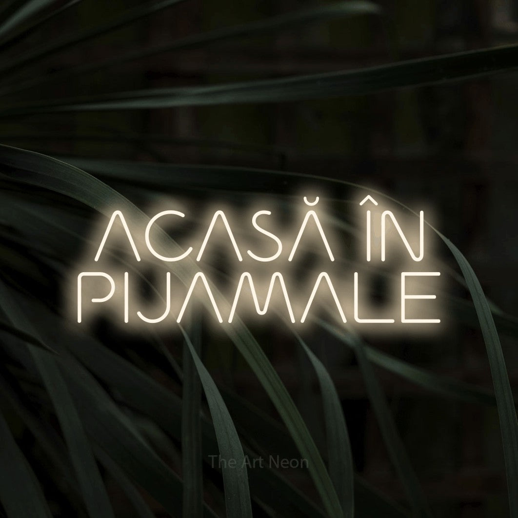 LED neon sign reading “ACASĂ ÎN PIJAMALE”, arranged in two lines.